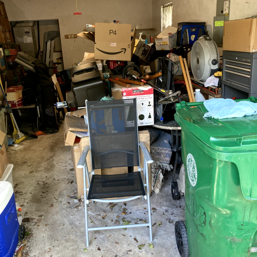 trash on a garage room with some cardboard boxes